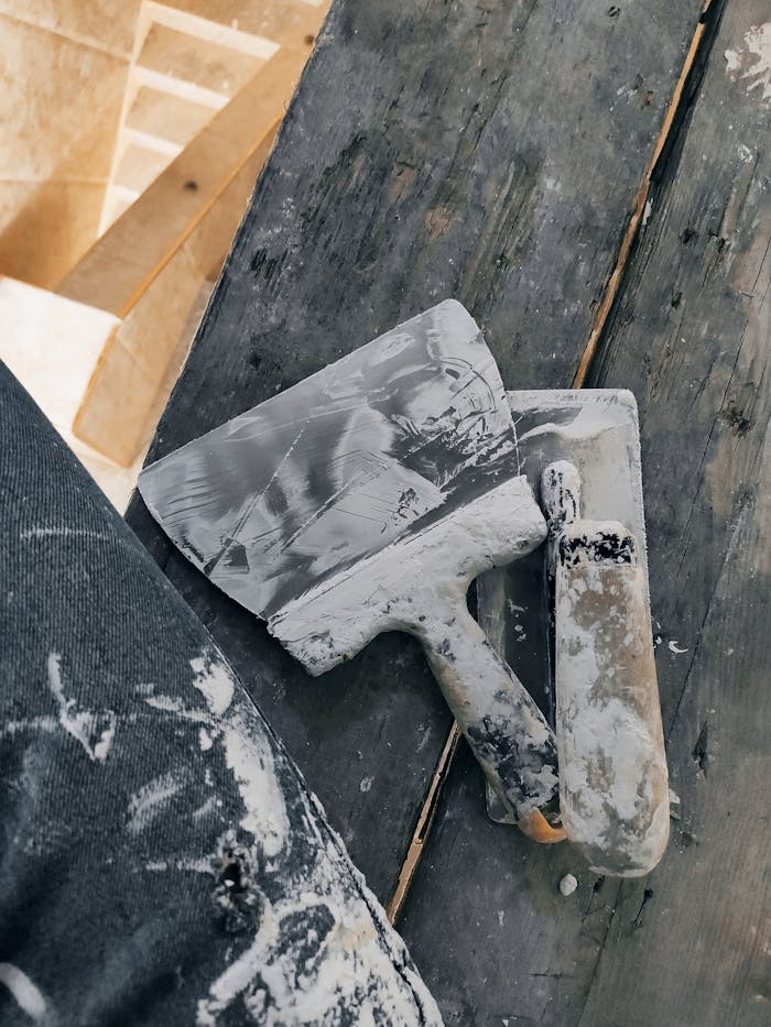 our-experience Close-up shot of used painting tools on a wooden surface, M'Sila, Algeria.